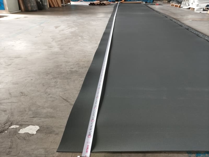 A 100 lb. roller used to secure a glue-down rubber floor